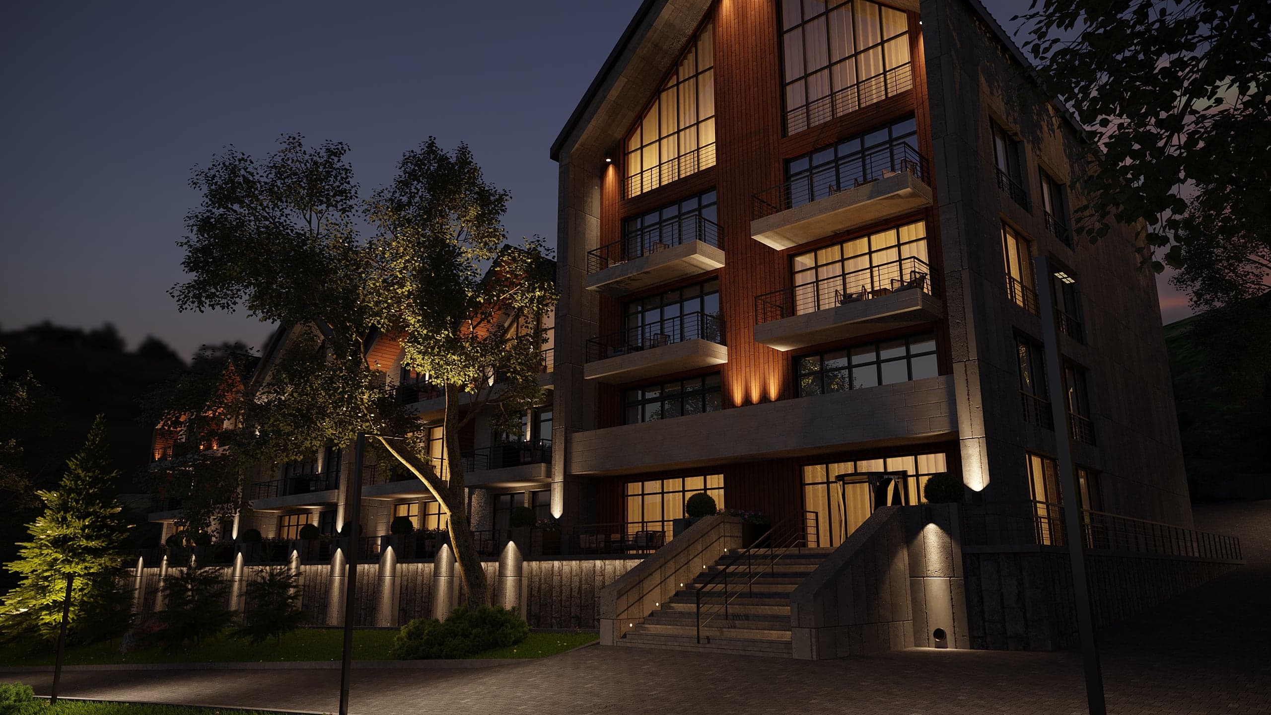 BELLIS Hotel & SPA main lodge illuminated at night — timber-lined pitched roofs and glazed entrance canopy