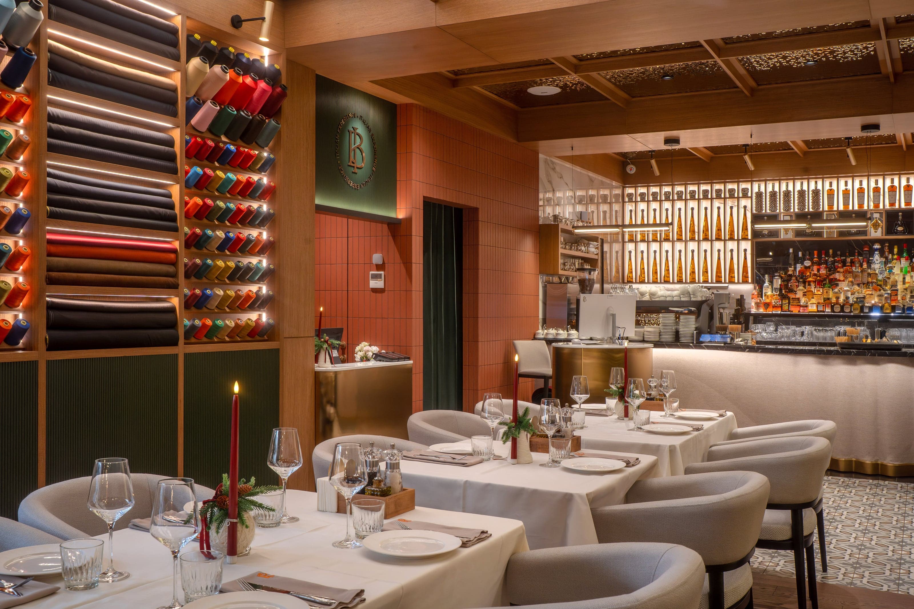 Bold Italic dining room with a tailoring-inspired wall of colored thread spools