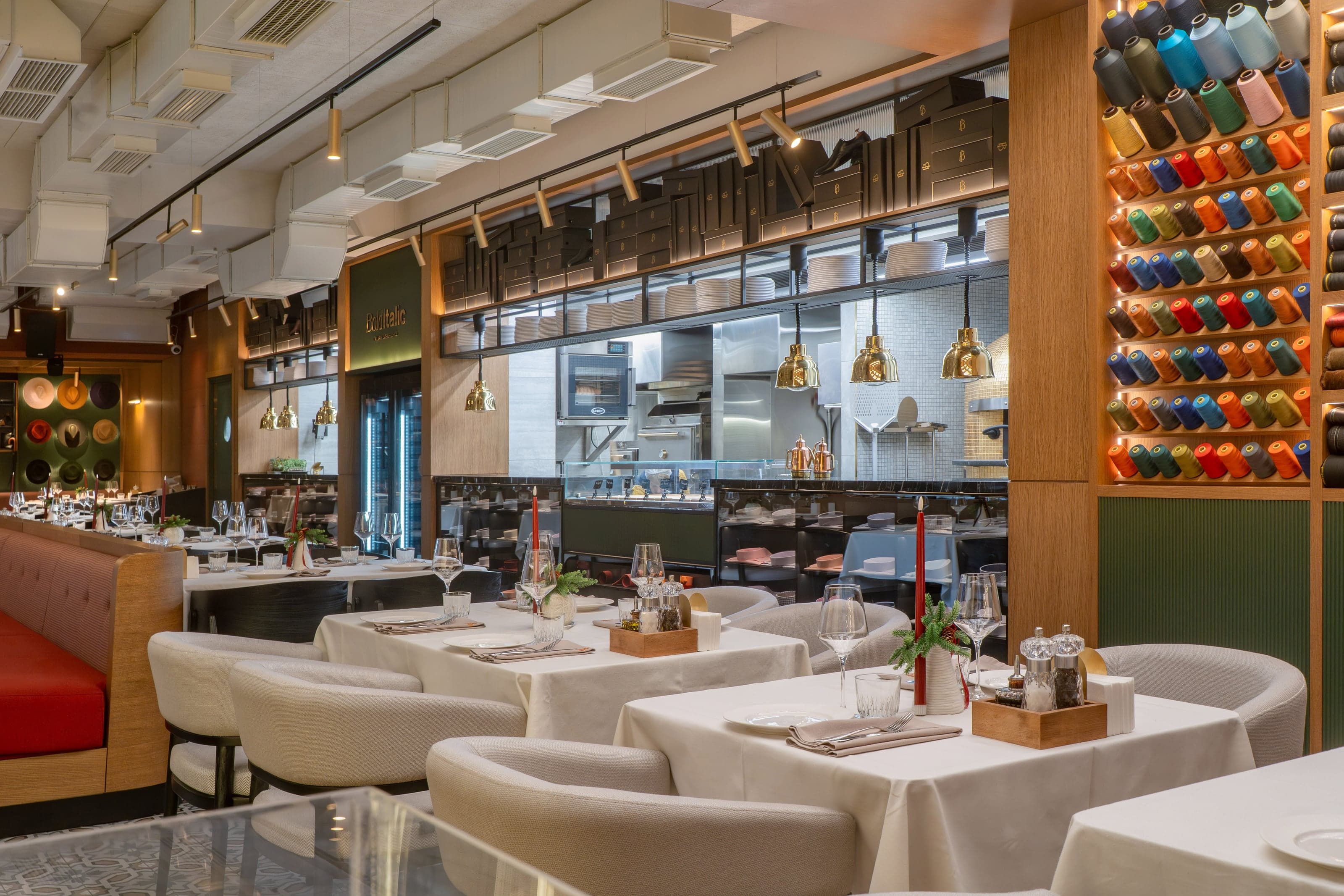 Bold Italic glass-enclosed terrace dining area with a suit rack and brass pendant lighting