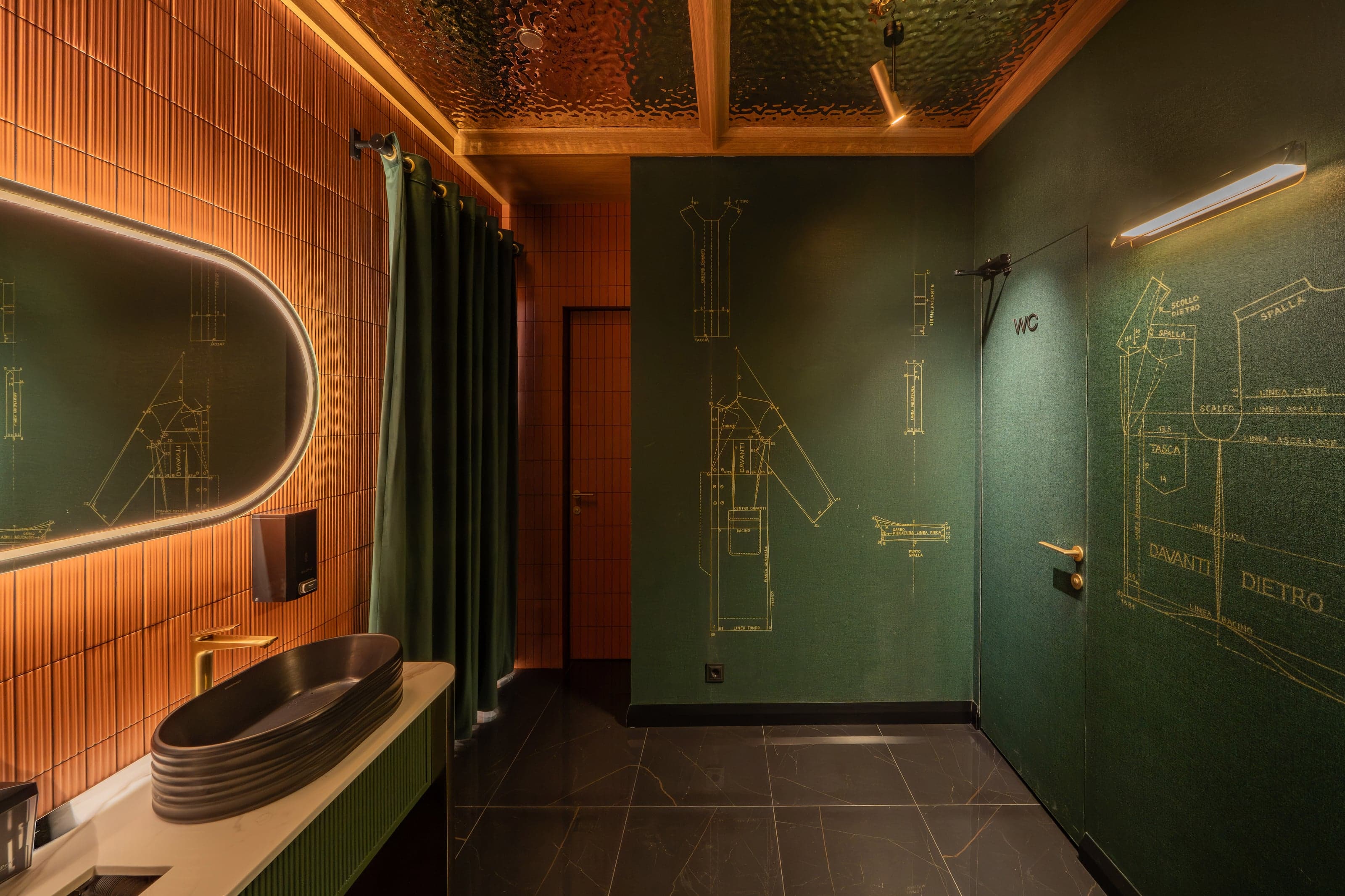 Bold Italic restroom with gold tailoring-pattern wallpaper and green tile