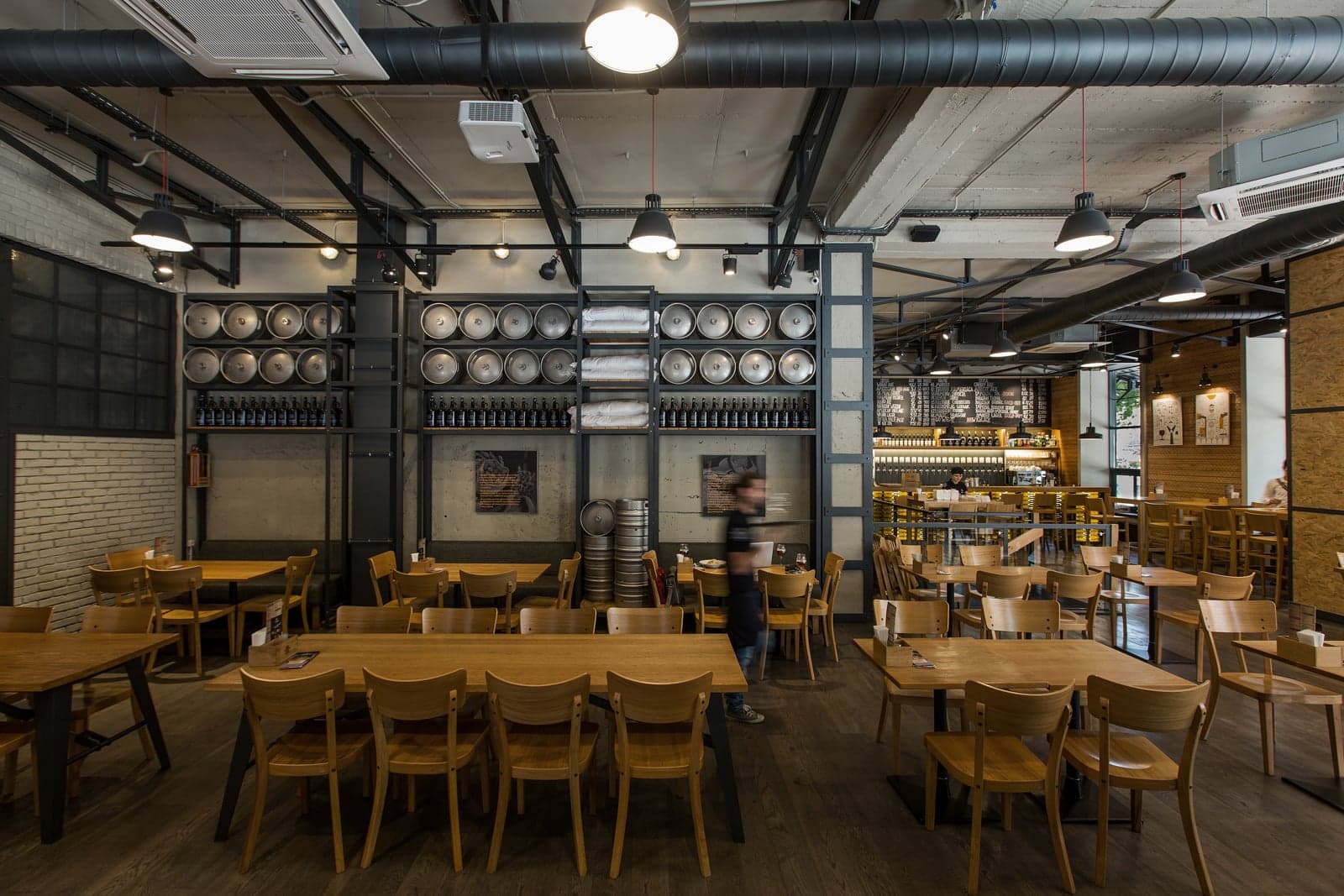 Restaurant interior featuring exposed brewing tanks