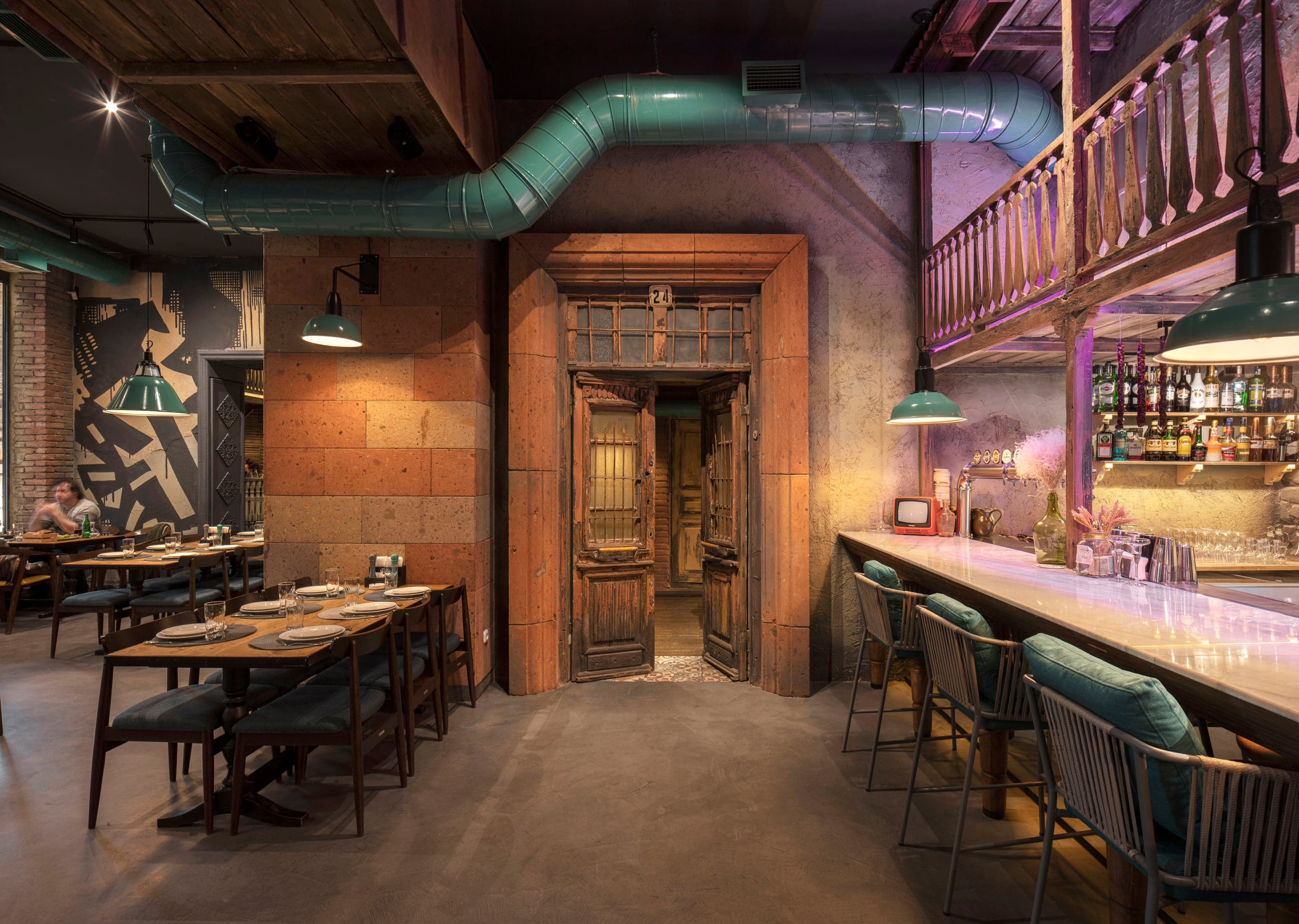 Warm restaurant interior with natural stone and wood finishes