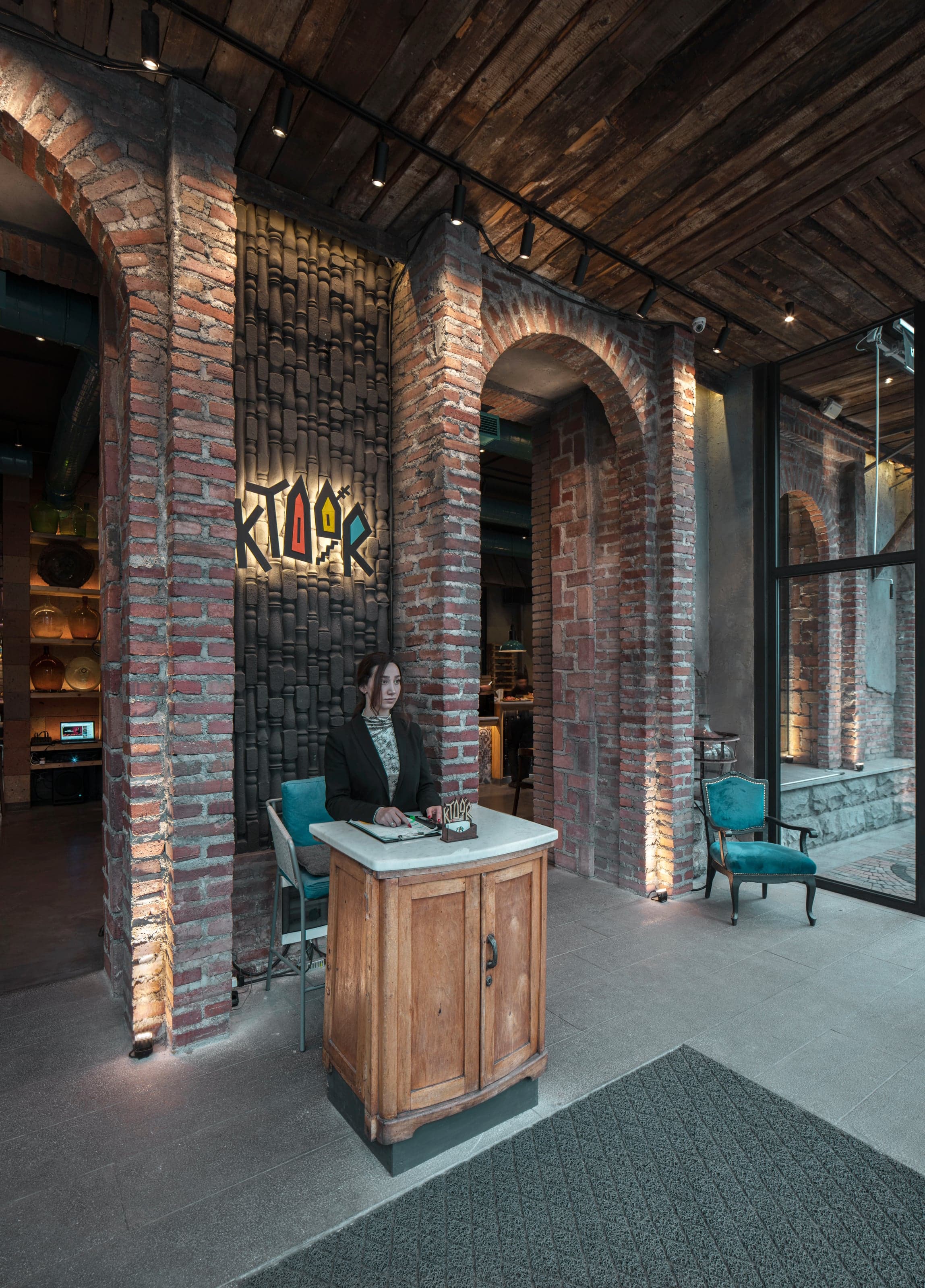 Warm restaurant interior with natural stone and wood finishes