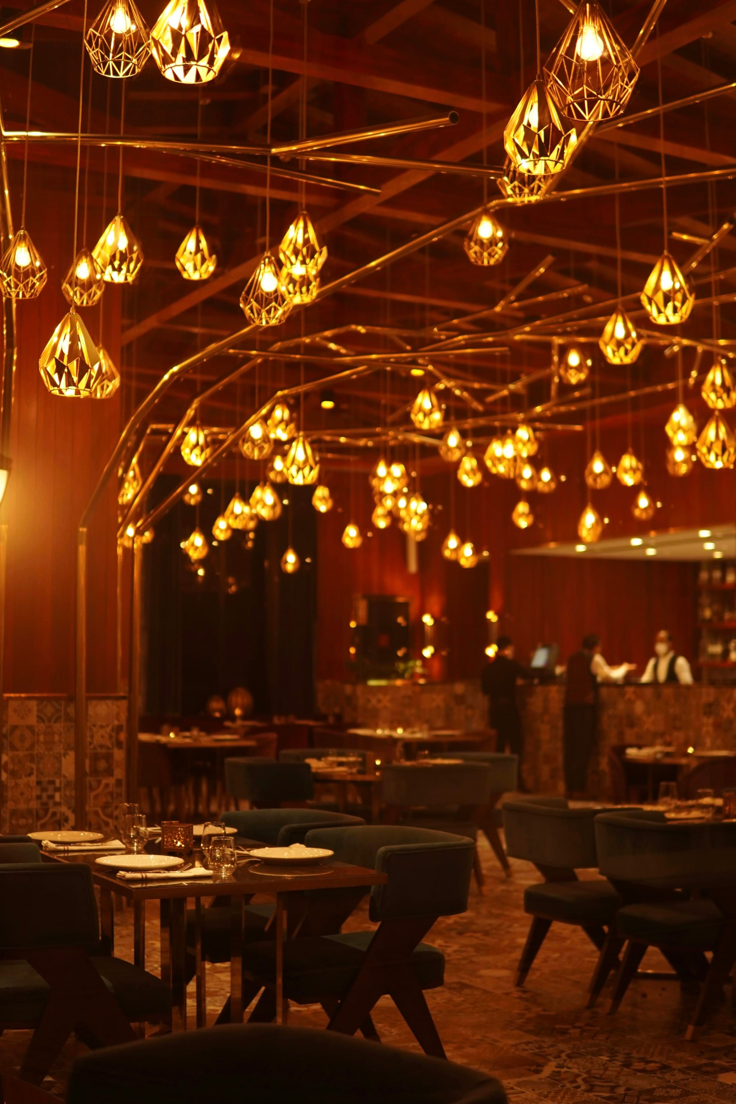 Warm hospitality interior with sculptural pendant lighting